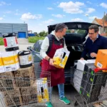 British travellers loading wine, beer kegs and spirits into a car after shopping in Calais, illustrating duty-free and tax-free alcohol purchases before returning to the UK.