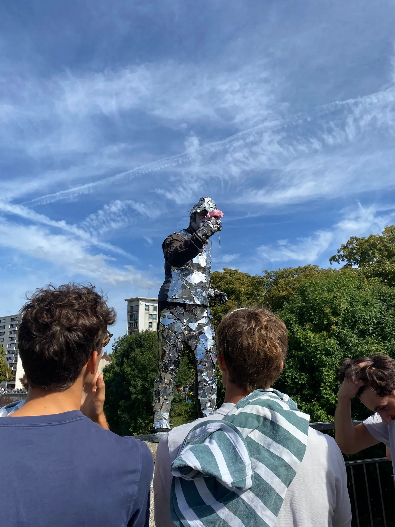 Street performer covered in mirror shards entertains the crowd during the Lille Braderie