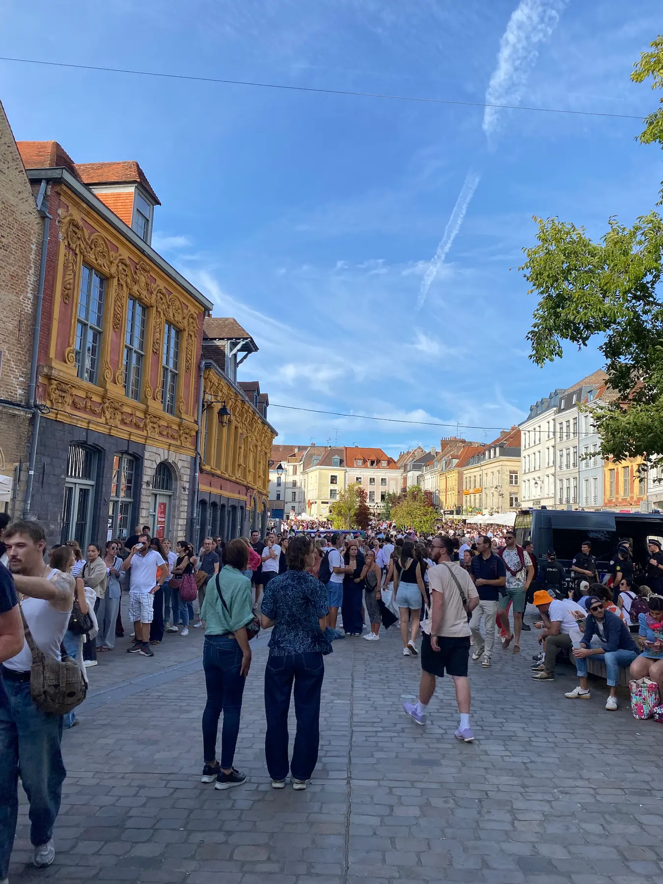 Dense crowd walking through a cobbled street in Vieux-Lille during the Braderie de Lille