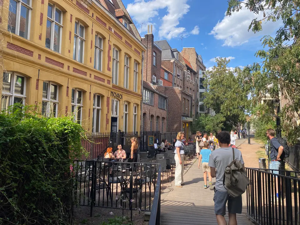 Hidden terraces along Rue des Weppes in Lille, accessed through a quiet pedestrian passage near the city centre.