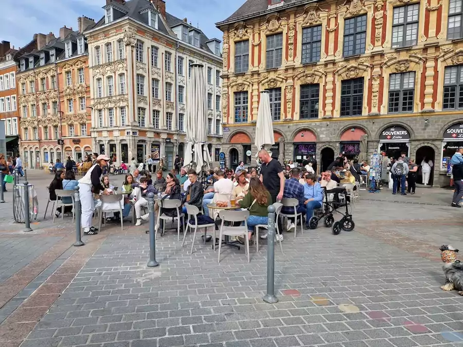 People enjoying time outside Lille Grand Place facing La vieille bourse